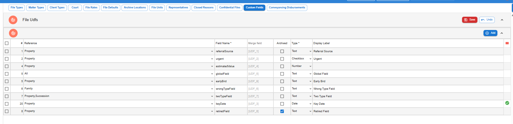 Settings, File Setup, Custom Fields screen listing firm-wide fields with their # display order, Reference file types, Field Name, read-only Merge field token, Archived tickbox, Type and Display Label columns.
